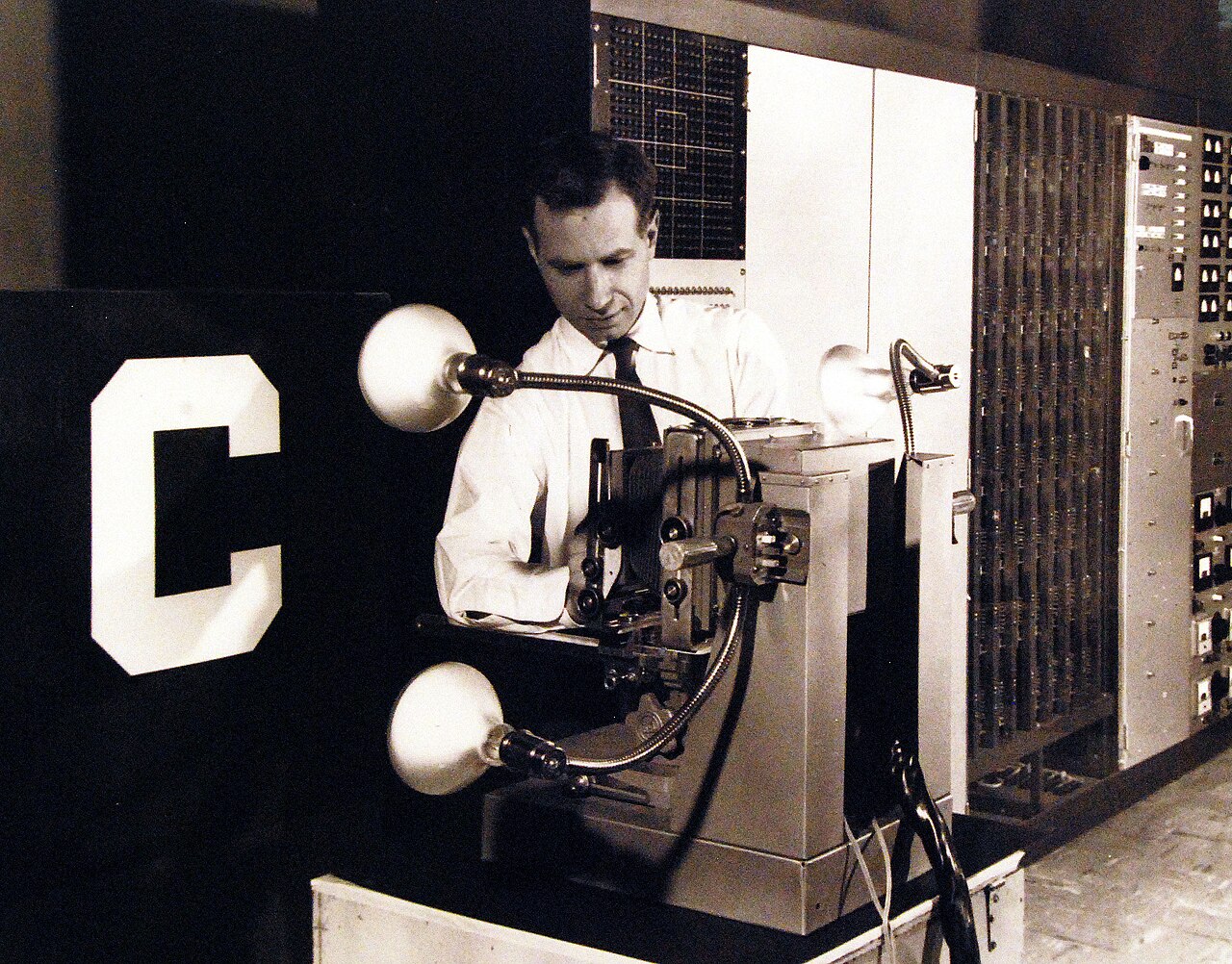 Frank Rosenblatt stands beside the Mark I Perceptron, a large electromechanical pattern-recognition machine.